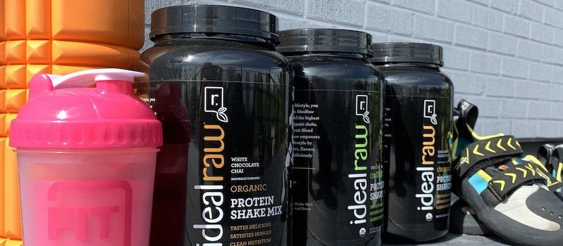 IdealRaw Protein Powder next to fitness equipment
