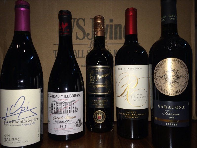 5 wine bottles lined up with the labels facing the camera