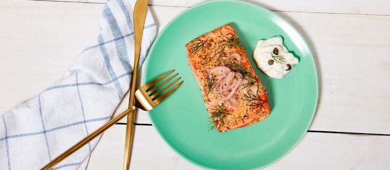 Plate of Wild Alaskan Company salmon and side of dressing