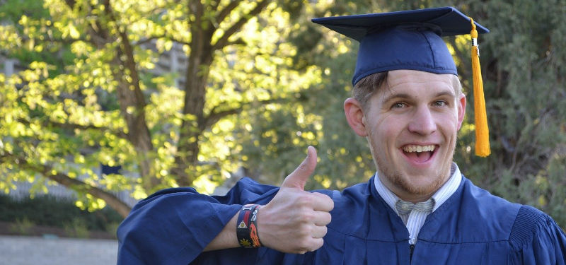 College grad with a thumbs up