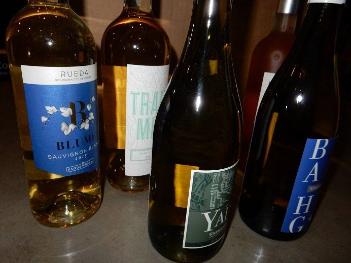 A close-up shot of several wine bottles with labels facing the camera