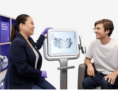 Doctor and patient look at 3D scans of teeth