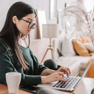 Woman uses laptop at coffee shop