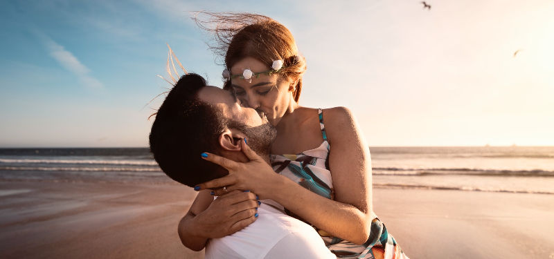 couple kissing on the beach