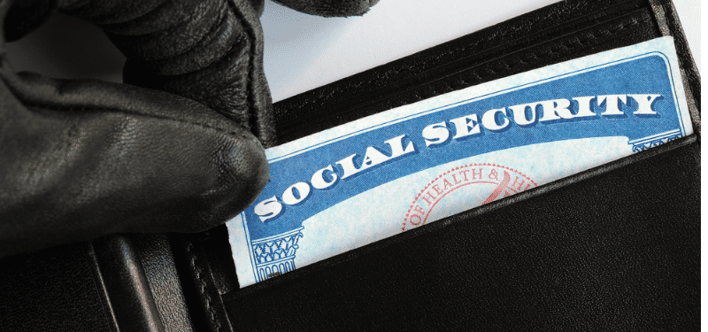 gloved hand taking social security card out of wallet