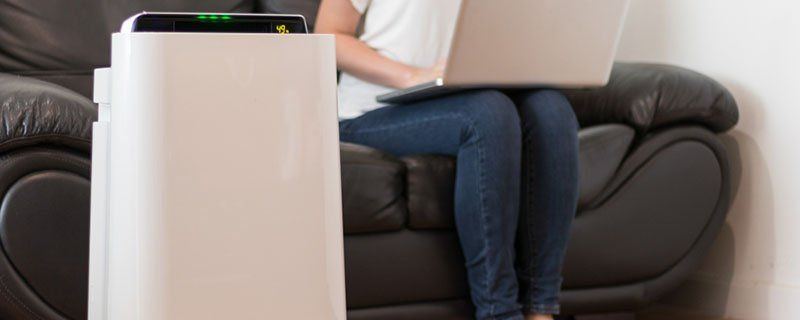 Air purifier next to couch