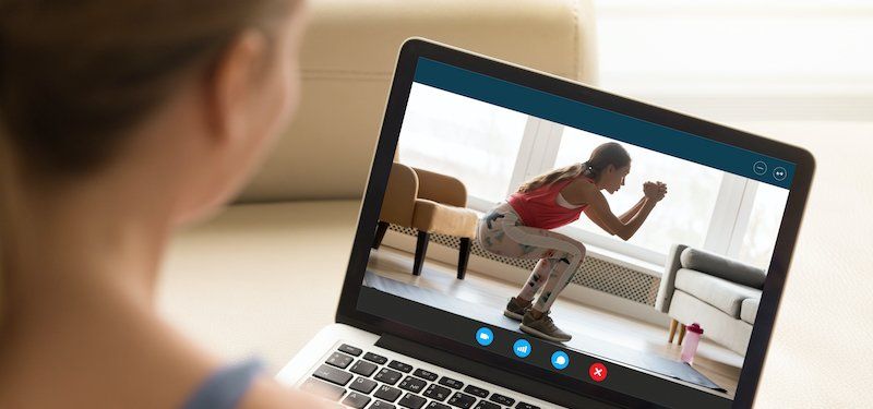 Woman looks at online workout video