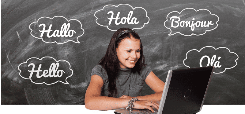 girl on laptop in front of a blackboard