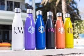 Row of different colored bottles lined up on bench